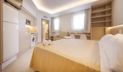 a hotel room with a bed and a living room at Sono House in La Garriga