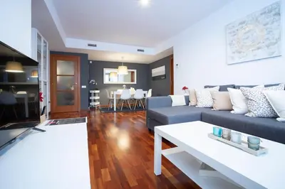 a living room with a couch and a table at Barcelona - Camp Nou in Hospitalet de Llobregat