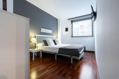a small bedroom with a bed and a window at Barcelona - Camp Nou in Hospitalet de Llobregat