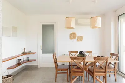 a patio with two chairs and an umbrella at Luxury Seaview Villa by Olala Homes in Teià