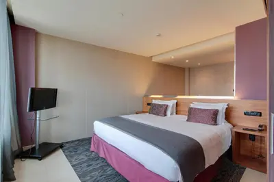 a hotel room with a bed and a tv at Hotel Badalona Tower in Badalona