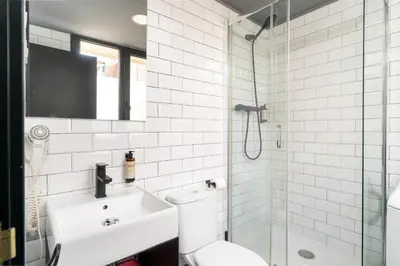a bathroom with a toilet and a sink and a shower at TSA La Mare in Barcelona