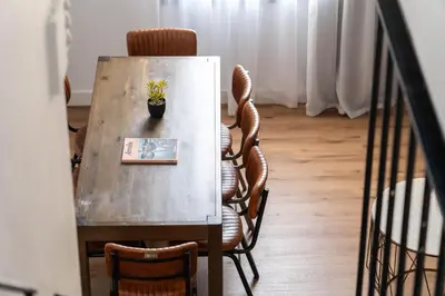 a table with chairs and a potted plant on it at TSA La Mare in Barcelona