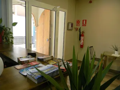 a room with a table with books and a plant at L'Hostalet d'Arenys de Mar in Arenys de Mar