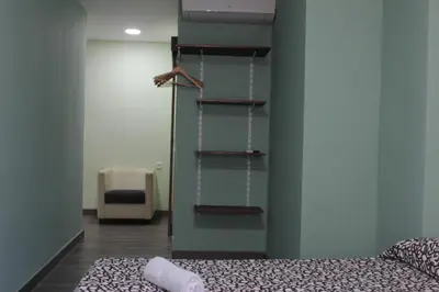 a bedroom with a bed and a book shelf at L'Hostalet d'Arenys de Mar in Arenys de Mar