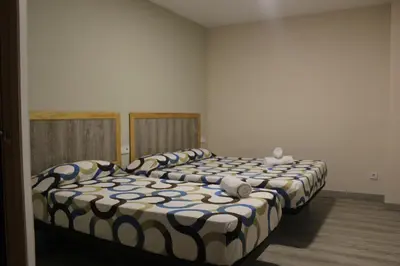two beds in a room with two at L'Hostalet d'Arenys de Mar in Arenys de Mar
