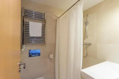a bathroom with a shower with a shower curtain at Apartment Barcelona Rentals - Swimming Pool with Terrace in Barcelona