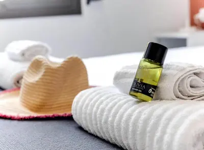 a bottle of soap sitting on top of a towel at City&Beach Apartments in City Center in Barcelona