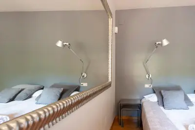 two beds in a room with a mirror at Apartment Barcelona Rentals - Classic Bonanova Apartment in Barcelona