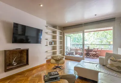 a living room with a couch and a fireplace at Apartment Barcelona Rentals - Classic Bonanova Apartment in Barcelona