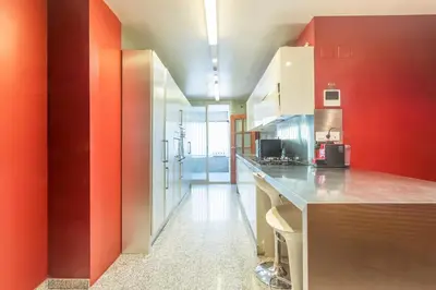 a kitchen with red walls and a counter top at Apartment Barcelona Rentals - Classic Bonanova Apartment in Barcelona