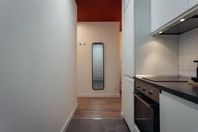 a kitchen with a counter and a mirror at Design Apartments by Olala Homes in Hospitalet de Llobregat