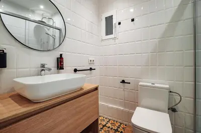 a white bathroom with a sink and a toilet at Design Apartments by Olala Homes in Hospitalet de Llobregat
