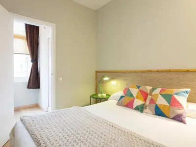a bedroom with a bed with a pillow and a window at Cozy Gracia 2 bedrooms in Barcelona