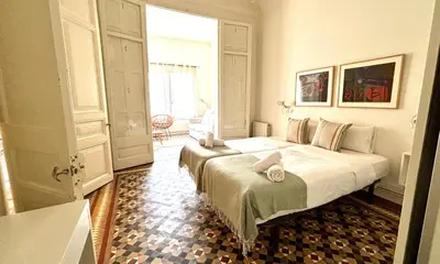 a dining room with a table and white chairs at Suites4days Plaça Catalunya Design in Barcelona