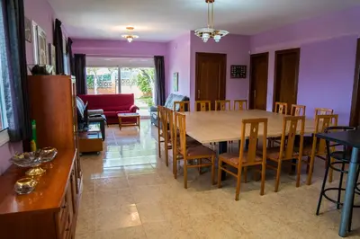 a dining room and living room with a table and chairs at Vista Cunit in Cubelles