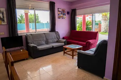a living room with two couches and a tv at Vista Cunit in Cubelles