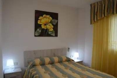 a bedroom with a bed and a painting on the wall at Vista Cunit in Cubelles