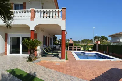 a villa with a swimming pool and a house at Vista Cunit in Cubelles