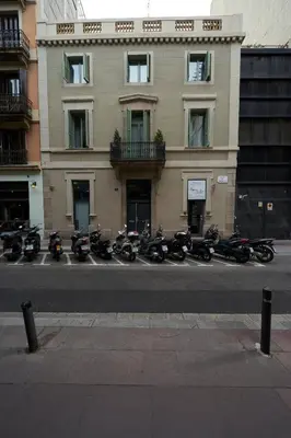 a row of motorcycles parked in front of a building at Bonavista Apartments - Passeig de Gracia in Barcelona