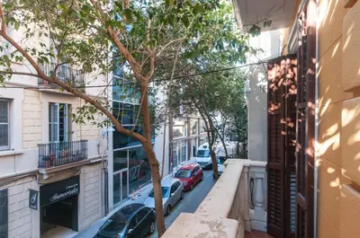 a street in the city with cars parked on the street at Sarriá - Sant Gervasi in Barcelona