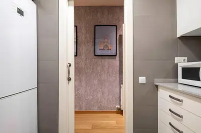 a kitchen with a microwave and a picture on the wall at Sarriá - Sant Gervasi in Barcelona