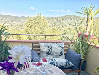 a balcony with a table and glasses of wine at Panoramic Apartments Sitges in Sitges