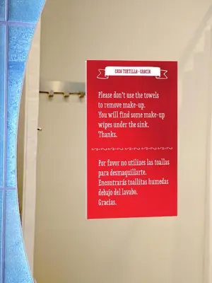 a red sign on a wall in a bathroom at Casa Tortilla Gracia in Barcelona