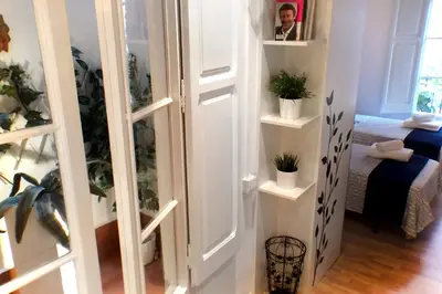 a room with a door with potted plants on shelves at Casa Tortilla Gracia in Barcelona