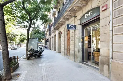 a scooter parked on a sidewalk in front of a store at Habitat Apartments Garden View in Barcelona
