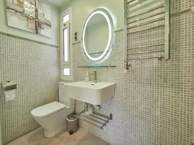 a bathroom with a sink and a toilet and a mirror at Unique Cozy Scenic Penthouse in Barcelona