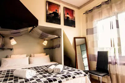 a bedroom with a bed with towels on it at Unique Cozy Scenic Penthouse in Barcelona