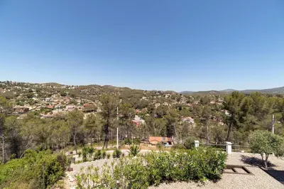 a view of a city from a hill with trees at Luxury Sitges Hills Villa in Olivella