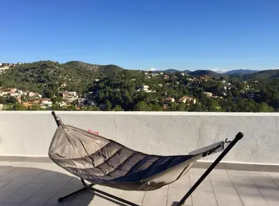 a hammock sitting on top of a roof at Luxury Sitges Hills Villa in Olivella