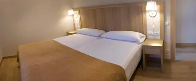 a bedroom with a large bed with two pillows at Apartamentos Voramar in Castelldefels