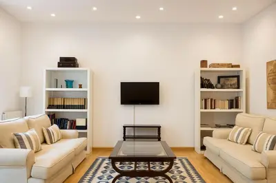 a living room with two couches and a tv at Habitat Apartments Bruc Terrace in Barcelona