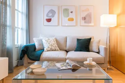 a living room with a couch and a glass table at Sibs Bcn- Balmes- Romantic CityCentre Beautiful in Barcelona