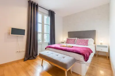 a bedroom with a large bed and a window at Sibs Bcn- Balmes- Romantic CityCentre Beautiful in Barcelona