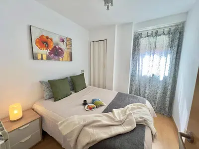 a bedroom with a bed with a stuffed animal on it at Nova Mar Bella Apartment in Barcelona