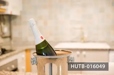 a bottle of champagne in a can on a counter at Elegant Sitges Apartment in Sitges