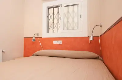 a bed in a room with a window at Charming Gracia 2 bedrooms in Barcelona