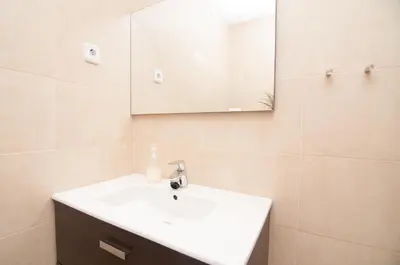a bathroom with a white sink and a mirror at Charming Gracia 2 bedrooms in Barcelona