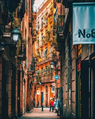 a city street with buildings and people walking down it at Camp Nou Apartment WiFi in Barcelona