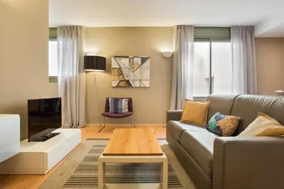 a living room with a couch and a table at Bonavista Apartments - Pedrera in Barcelona