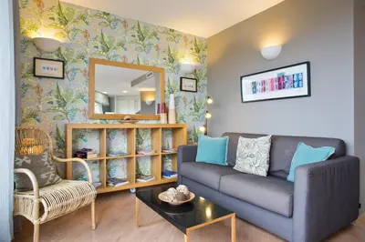 a living room with a couch and a mirror at Bonavista Apartments - Pedrera in Barcelona