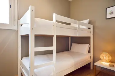 a couple of bunk beds in a room at Bonavista Apartments - Pedrera in Barcelona