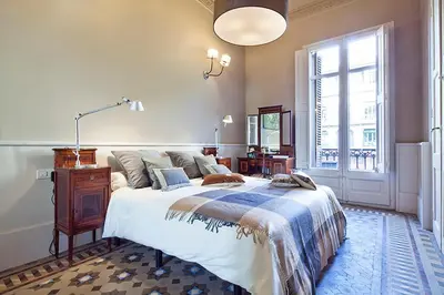 a bedroom with a large bed and a window at Apartment Barcelona Rentals - Rambla de Catalunya Center in Barcelona