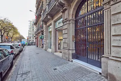 a street with cars parked next to a building at Apartment Barcelona Rentals - Rambla de Catalunya Center in Barcelona