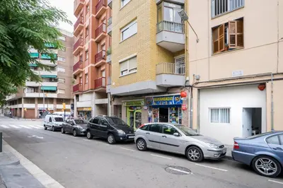 a group of cars parked on the side of a street at Hotelito Boutique Camp Nou in Hospitalet de Llobregat