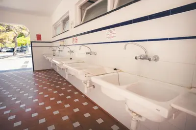 a row of sinks in a public restroom at HolaCamp Sitges Relax in Sitges